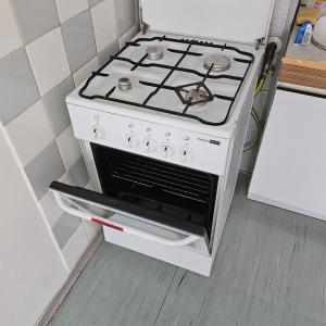 a stove in a kitchen with an open oven at Izba v dome manželská dvojposteľ in Svidník