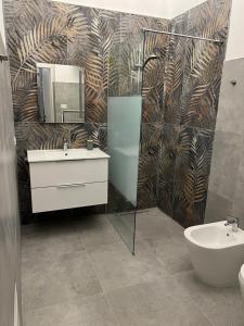 a bathroom with a sink and a mirror and a toilet at Appartamenti Tiffany & Timi in Carini +56 photos