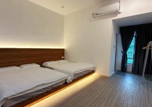 a bedroom with two beds and a window at The Luxurious 23, GameTopia Villa in Johor Bahru +75 photos
