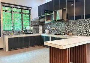 a kitchen with blue cabinets and a large window at The Luxurious 23, GameTopia Villa in Johor Bahru
