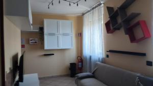 a living room with a couch and a white cabinet at Vera Alloggio Alessandria nr1 in Alessandria