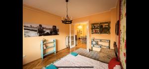 a living room with yellow walls and a hallway at Best Location cosy Art flat in Budapest