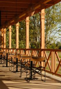 a row of tables and chairs under a gazebo at Samzeo Kvareli in Kvareli +78 photos