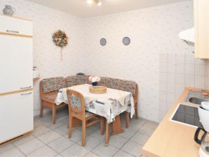 a kitchen with a table and chairs with flowers on it at Family Fun Near Devil s Wall in Blankenburg