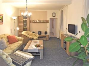 a living room with a couch and a tv at Family Fun Near Devil s Wall in Blankenburg +31 photos