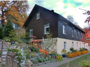 a black house with a garden in front of it at Family Fun Near Devil s Wall in Blankenburg