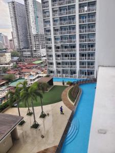 a person standing in front of a large building at SMDC Breeze Residences in Manila