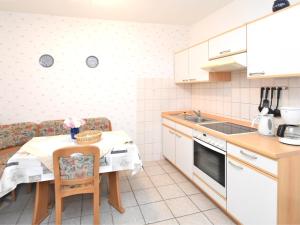 a small kitchen with a table and a counter top at Family Fun Near Devil s Wall in Blankenburg