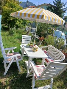 a table and two chairs and an umbrella at La casa nel verde in Rapallo