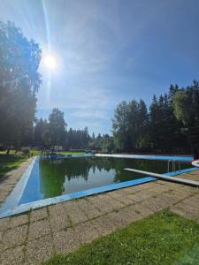 a pool of water with the sun reflecting in it at Corso Harrachov Apartment 303 in Harrachov