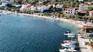 an aerial view of a beach with boats in the water at Anić Apartment in Seget Vranjica +7 photos