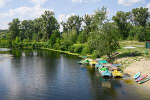 a group of boats are docked on a river at Мис Доброї Надії Полтава in Hlody +97 photos