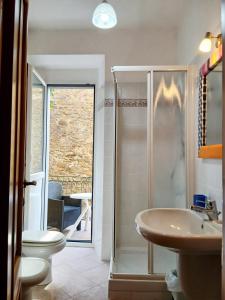 a bathroom with a shower and a toilet and a sink at Casa Vacanze Caterina in Corniglia