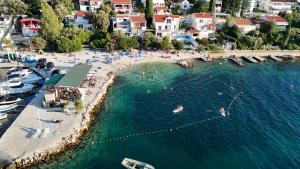 an aerial view of a beach with people in the water at Anić Apartment in Seget Vranjica