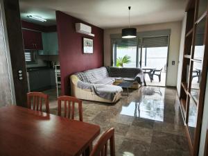 a living room with a couch and a table at Adosado cerca del mar con piscina privada in Vinaròs