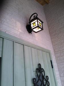 a light on the side of a house with a door at Rental villa Yukura Nakijin near Janglia Okinawa and Churaumi Aquarium in Nakijin