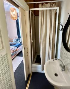 a bathroom with a sink and a mirror at Mer & Côte Fleurie Plage à pied in Merville-Franceville-Plage