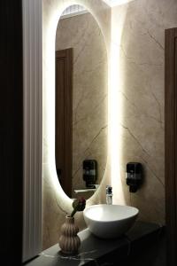 a bathroom with a white sink and a mirror at Forrest Hotel in Skhidnitsa +21 photos