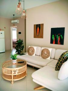 a living room with a couch and a coffee table at Blue Paradise - Gjiri i Lalezit in Lalzit Bay