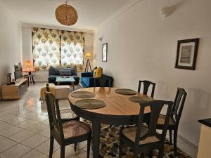 a living room with a wooden table and chairs at Maarif Central Stay in Maarif