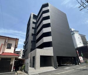 a black and white building on a city street at ステイインアット勝富 in Sasebo
