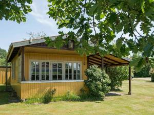a tiny house with a large window at 4 person holiday home in Nordborg in Nordborg