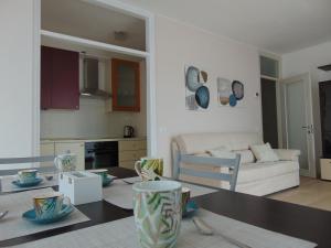 a kitchen and living room with a table and a couch at Torre 2 in Longarone