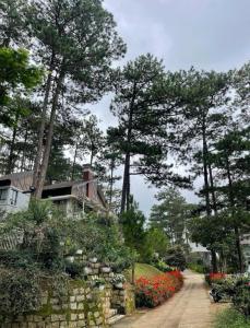 a house with trees and flowers on a driveway at Lan anh Village - Luxury villa Tuyen lam lake view in Xuan An +42 photos