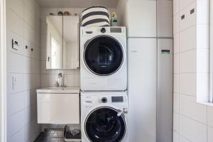a washer and dryer in a small bathroom at Lakeside Family Home in Gräddö in Gräddö