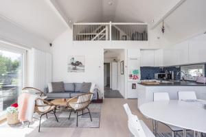a kitchen and living room with a couch and a table at Lakeside Family Home in Gräddö in Gräddö