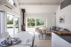 a kitchen and living room with a table and chairs at Lakeside Family Home in Gräddö in Gräddö +21 photos
