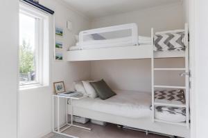 a small bedroom with bunk beds and a window at Lakeside Family Home in Gräddö in Gräddö