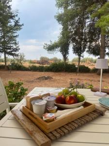 a tray of fruit and cheese on a table at Arneo Rooms in Torre Lapillo
