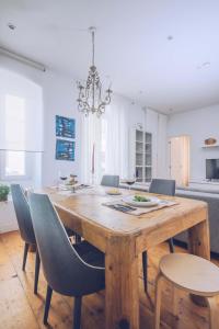 a dining room with a wooden table and chairs at Eclectic 2BR with shared terrace perfect getaway in Gibraltar