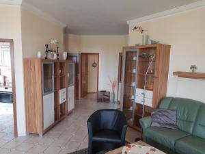 a living room with a couch and a chair at Gruppenunterkunft mit Pool in Ballenstedt in Ballenstedt