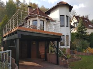 a house with a balcony on top of it at Gruppenunterkunft mit Pool in Ballenstedt in Ballenstedt