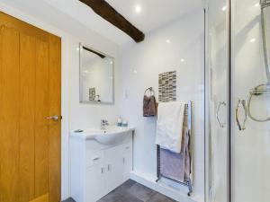 a bathroom with a sink and a shower at Woodman's Cottage, Penrith in Penrith