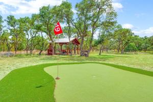 a golf course with a red flag on the green at Three Sisters - Casita 3 in Wimberley