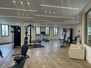 a gym with treadmills and exercise equipment in a room at BURJ ON BAY Hotel in Jounieh