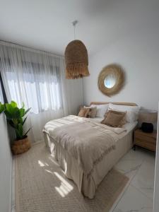 a bedroom with a bed and a large window at PMT22 - Luxury villa with private heated pool and jacuzzi in Torrevieja
