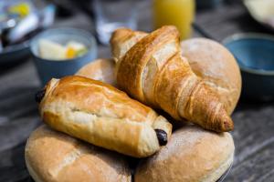a pile of bread sitting on top of a table at Poutrelle Guestrooms in Bruges
