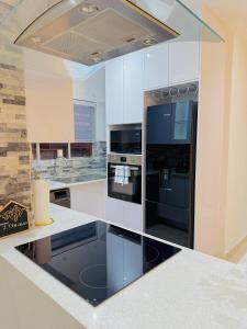 a kitchen with a black refrigerator and a stove at Beautiful Luxury Apartment in Johannesburg