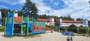 a playground in front of a building at Prémiový apartmán s privátní saunou a terasou v blízkosti Lipenské nádrže a lyžařského střediska in Lipno nad Vltavou