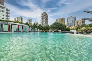 a large pool of clear blue water in a city at Tallest Tower SkyHomes | 9 Hamilton Avenue in Gold Coast