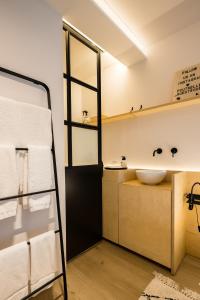 a bathroom with a sink and a mirror at Poutrelle Guestrooms in Bruges +32 photos