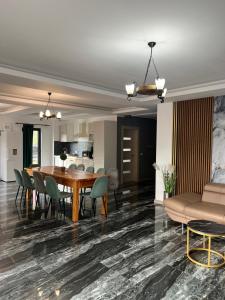 a dining room and living room with a table and chairs at CABANA BELVEDERE in Borşa