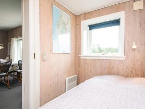 a bedroom with a bed and a window at 4 person holiday home in Vejers Strand-By Traum in Vejers Strand