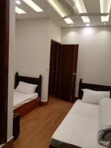a room with two beds in a room at 8 Rawal Inn in Dargai