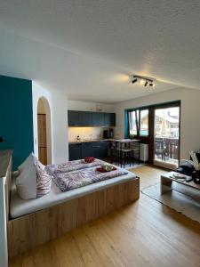 a bedroom with a large bed in the middle of a room at Haus Sylta in Fischen
