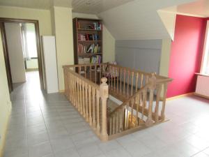 a staircase in a room with a book shelf at Sun-kissed Villa in Diksmuide with Garden, Sauna in Diksmuide +32 photos